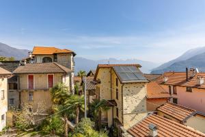 a view of a town with mountains in the background at Antica Villa Branca by Lago Maggiore Rentals in Cannobio
