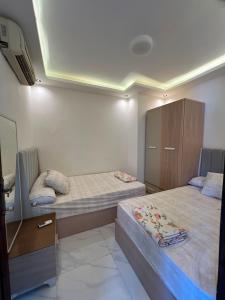 a room with two beds and a cabinet in it at عماره 227 in El Alamein