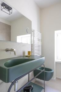 a bathroom with a green sink and a toilet at Antica Villa Branca by Lago Maggiore Rentals in Cannobio +77 photos