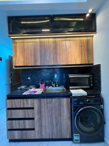 a kitchen with a sink and a washing machine at عماره 227 in El Alamein