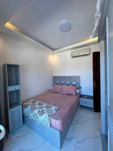 a bedroom with a bed in a small room at عماره 227 in El Alamein