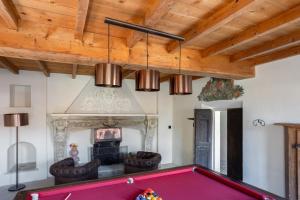 a pool table in a living room with a ceiling at Antica Villa Branca by Lago Maggiore Rentals in Cannobio