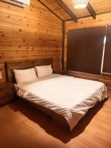 a bedroom with a bed in a wooden room at اكواخ بيلا 2 in Taif