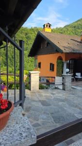 a house with a patio in front of it at Respiro di montagna by Lago Maggiore Rentals in Vigino