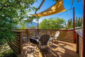 a deck with chairs and a table and a grill at Artbliss Hotel in Stevenson