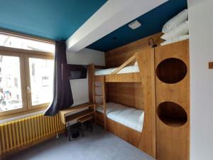 a room with two bunk beds and a desk at Hotel La Verticale in Chamonix