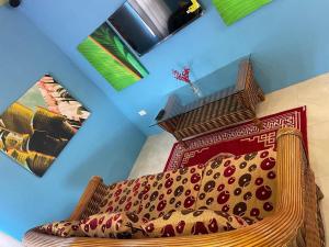 a room with a couch and a chair in a room at Attre guesthouse in Basseterre