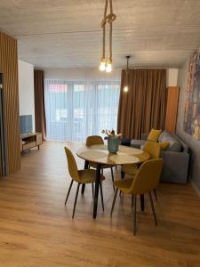 a living room with a table and chairs and a couch at Diamond Houses in Námestovo