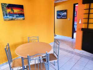 a dining room with a table and chairs at Villa Bonita Torre 16 in Cozumel +10 photos