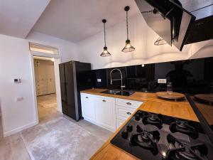 a kitchen with a black refrigerator and a counter top at Luxury Apartments C in Braşov +2 photos
