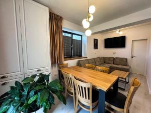 a living room with a wooden table and a couch at Luxury Apartments C in Braşov