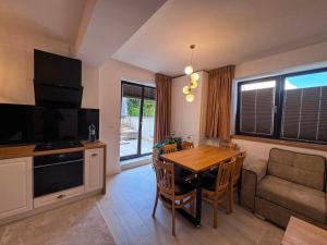 a living room with a table and a couch at Luxury Apartments C in Braşov