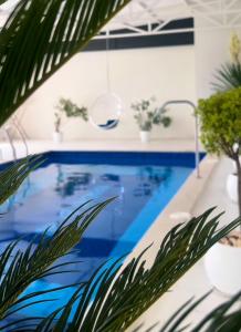 a blue swimming pool with plants and a faucet at Rancho by HV in Sevan