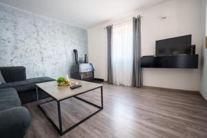 a living room with a couch and a coffee table at Villa Pantheon Mostar in Blagaj