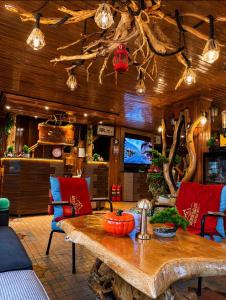a living room with a wooden table and chairs at Ayder Avusor Hotel in Ayder Yaylasi