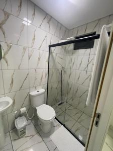 a bathroom with a toilet and a shower at Loft Conteiner in Primavera do Leste