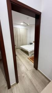 a mirror in a room with a bed and a bedroom at صلالة صحلنوت in Salalah