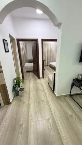 a living room with a wooden floor and a hallway at صلالة صحلنوت in Salalah +3 photos