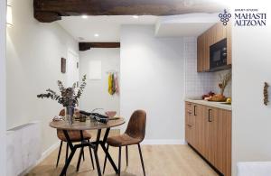 a kitchen with a table and two chairs at ALTZOAN Apartamentos Turísticos y aparcamiento gratuito in Zarautz +20 photos