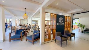 a restaurant with blue chairs and people sitting at tables at Blie Hotéis - Inauguração in Bonito