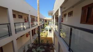 an empty hallway of a building with a palm tree in the middle at Blie Hotéis - Inauguração in Bonito