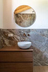 a bathroom with a sink and a mirror on a counter at Glamping Tenuta Ca'Nova in Mestrino