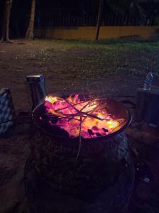 a fire pit in a yard at night at Girassol praia hotel in Valença