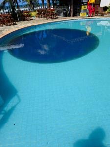 a large blue swimming pool with blue water at Girassol praia hotel in Valença