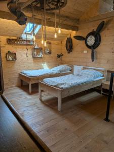 a room with two beds and a clock on the wall at Gästehaus LeLo 7 in Solingen