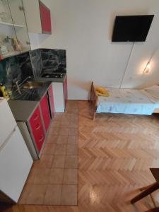 a small kitchen with a bed in a room at Apartmants Emy in Novalja