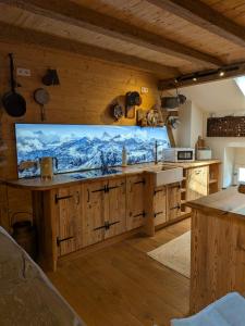 a kitchen with a large tv on the wall at Gästehaus LeLo 7 in Solingen +14 photos