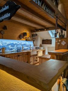 a kitchen with wooden cabinets and a counter top at Gästehaus LeLo 7 in Solingen