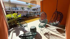 a balcony with chairs and lights in a building at Blie Hotéis - Inauguração in Bonito +25 photos