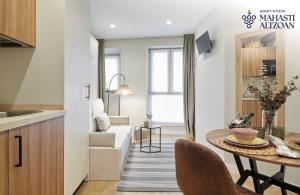 a kitchen and living room with a table and a dining room at ALTZOAN Apartamentos Turísticos y aparcamiento gratuito in Zarautz
