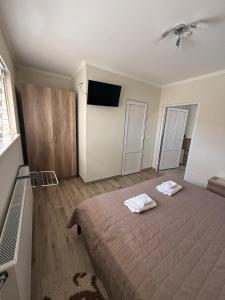a bedroom with a bed with two towels on it at Hotel ELYSIUM in Irshava