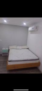 a bedroom with a bed in a room at Hafi in Païta