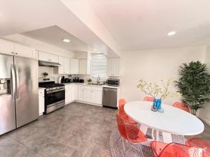 a kitchen with a table and red chairs in it at Charming 3BR Beverly Retreat with Large Private Backyard Bedford in Los Angeles