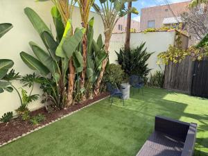 a garden with chairs and plants and a fence at Charming 3BR Beverly Retreat with Large Private Backyard Bedford in Los Angeles