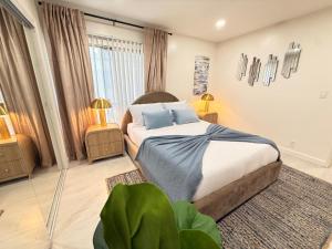 a bedroom with a large bed and two lamps at Charming 3BR Beverly Retreat with Large Private Backyard Bedford in Los Angeles