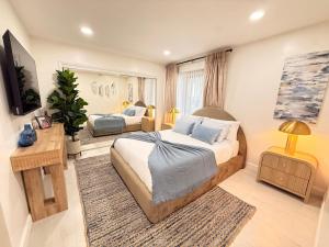 a bedroom with a large bed and a mirror at Charming 3BR Beverly Retreat with Large Private Backyard Bedford in Los Angeles