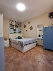 a bedroom with a bed and a blue dresser at Casa La Tapita in Marbella