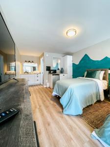a bedroom with a large bed with a blue headboard at Meadow Room at The Trailblazer Unit 12 in Townsend
