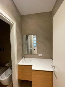 a bathroom with a sink and a mirror at Solea Home in Termoli