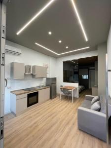 a kitchen and living room with a couch and a table at Solea Home in Termoli