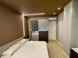 a bedroom with a large white bed and a mirror at Solea Home in Termoli