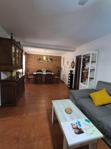 a living room with a couch and a table at Casa La Tapita in Marbella