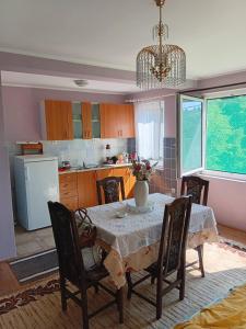 a kitchen with a table with a vase on it at Ljiljana apartmani Banja Vrujci in Rakari