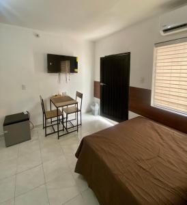 a bedroom with a bed and a table and chairs at Depas Expo Estadio in Monterrey