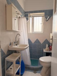 a bathroom with a sink and a toilet at KROKOS HOUSE in Aliveri