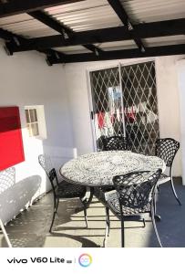 a table and chairs and a table and a table and chairs at Firehouse self-catering cottage 7 in Wellington
